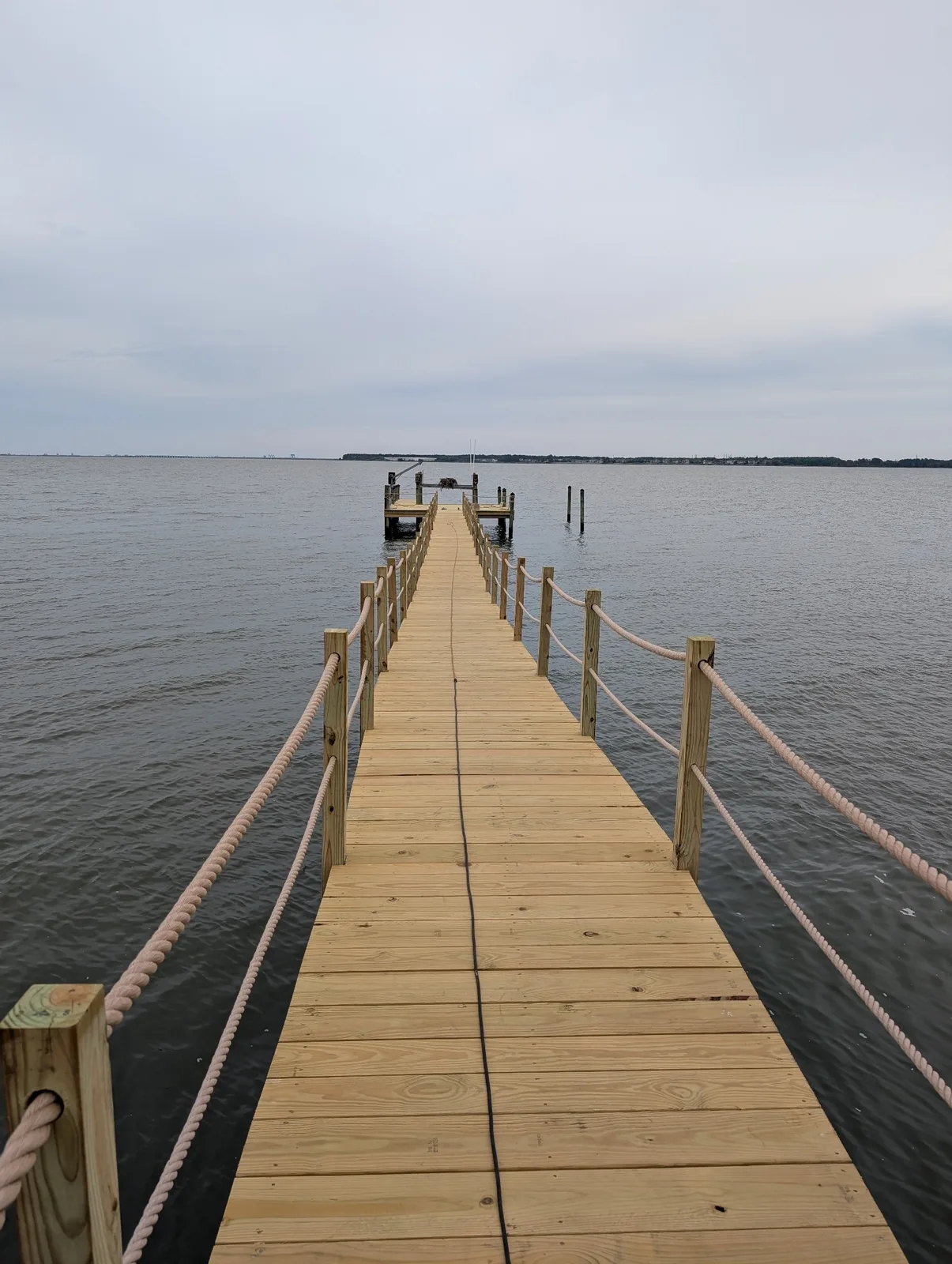 Finished pier walkway extending over the water